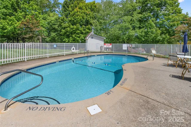 a view of a backyard with a sink and wooden fence