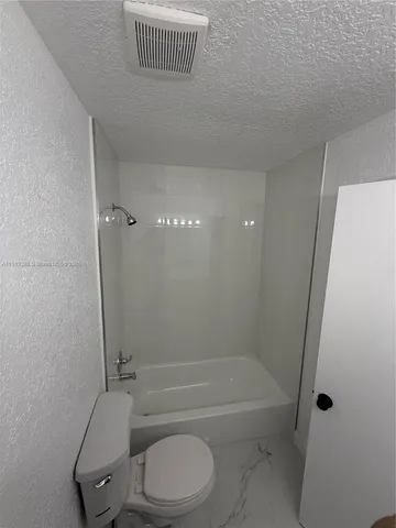 a bathroom with a toilet a sink and bathtub