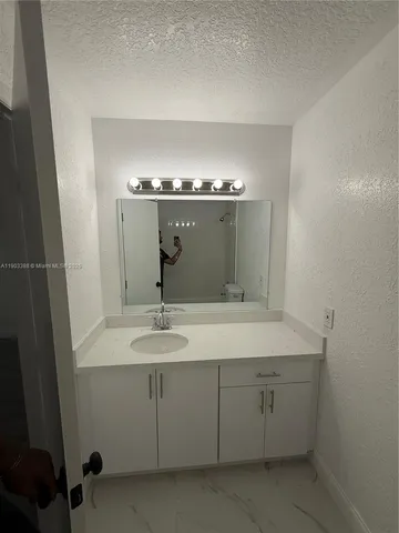 a bathroom with a sink and mirror
