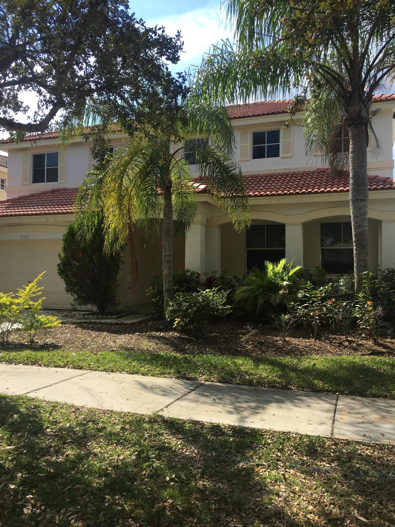 a view of house with yard and green space