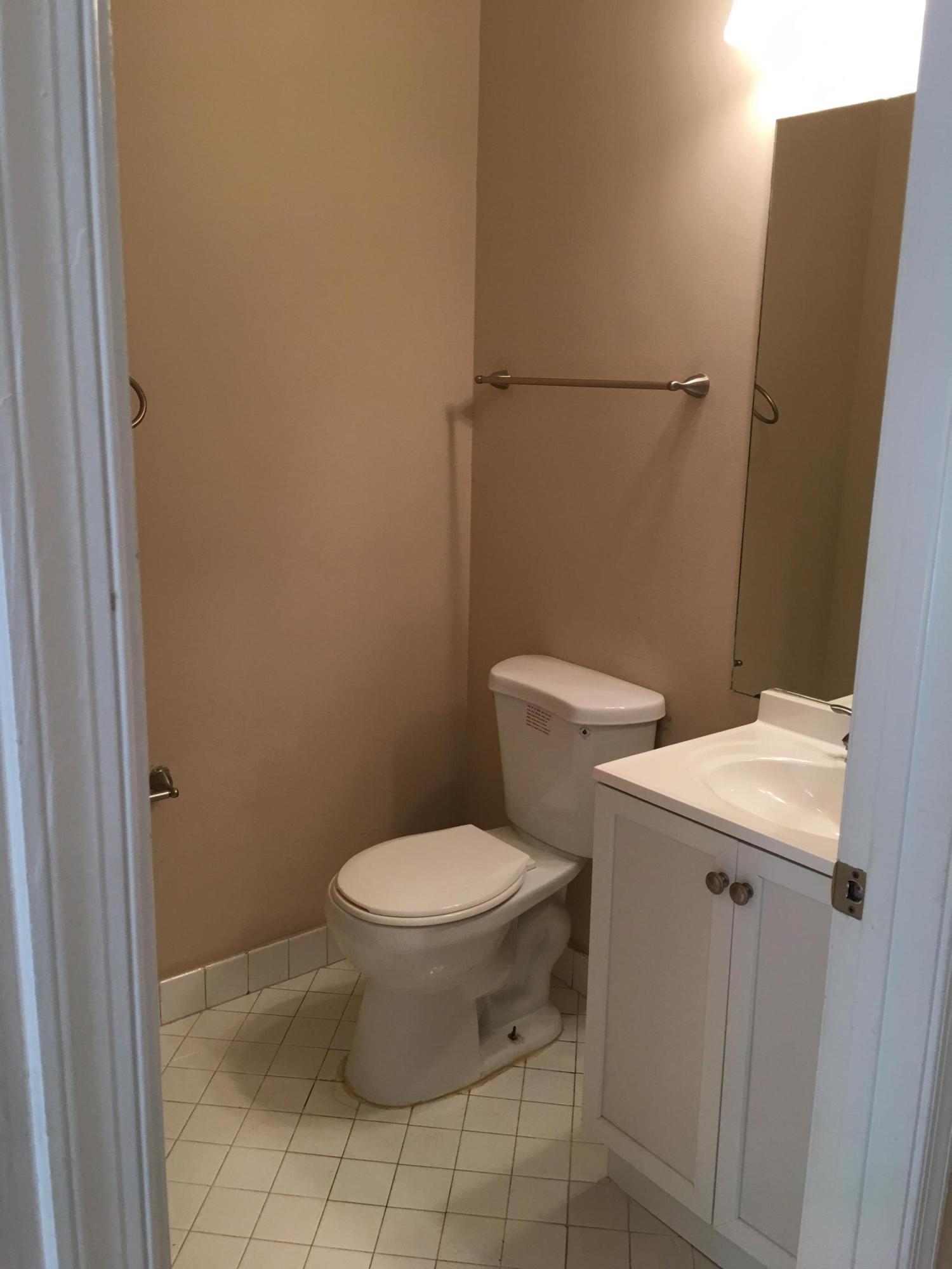 4383 Laurel Ridge Circle Weston, FL 33331 - Photo 15 of 36 a white toilet sitting next to a shower curtain
