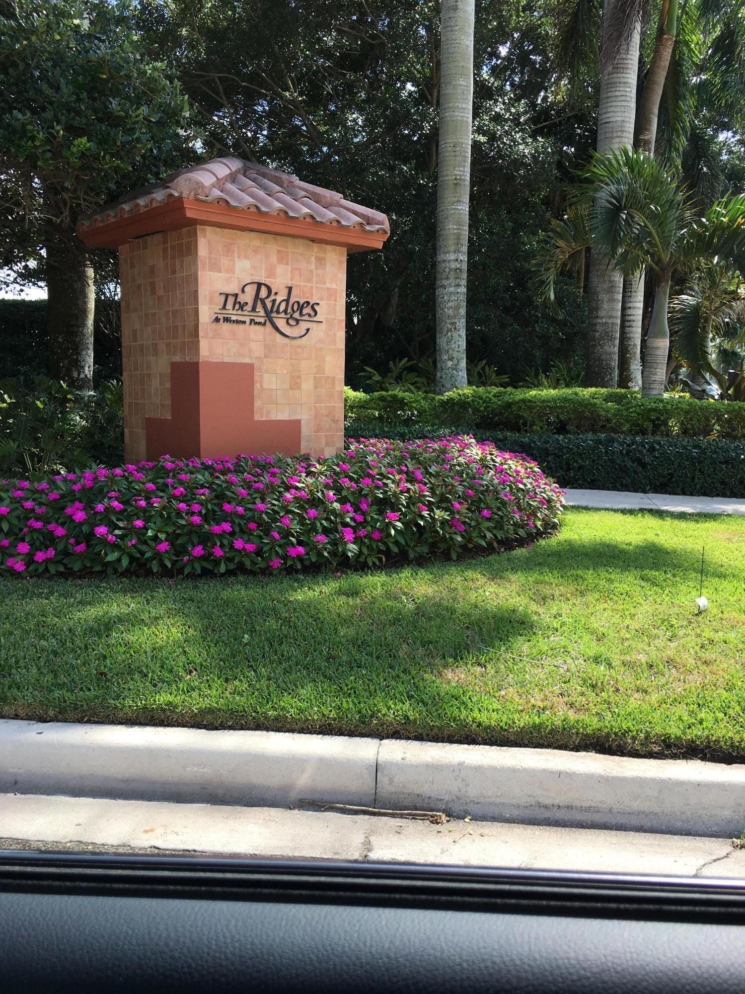 4383 Laurel Ridge Circle Weston, FL 33331 - Photo 2 of 36 a view of a sign in front of a house
