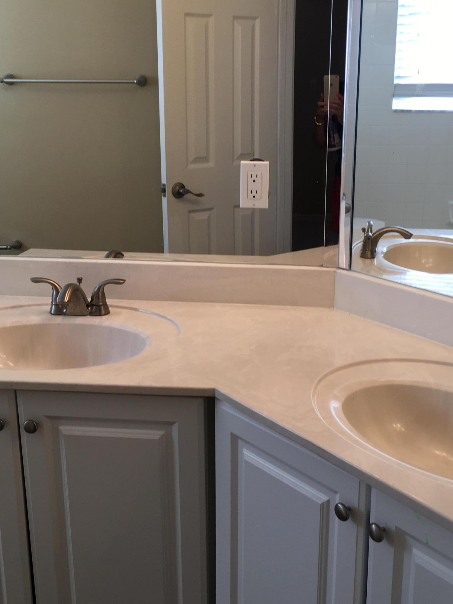 4383 Laurel Ridge Circle Weston, FL 33331 - Photo 21 of 36 a bathroom with a sink and a mirror
