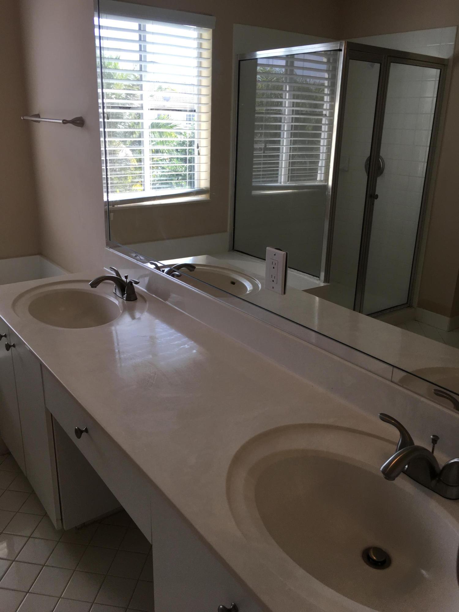 4383 Laurel Ridge Circle Weston, FL 33331 - Photo 23 of 36 a bathroom with a granite countertop sink and a bathtub