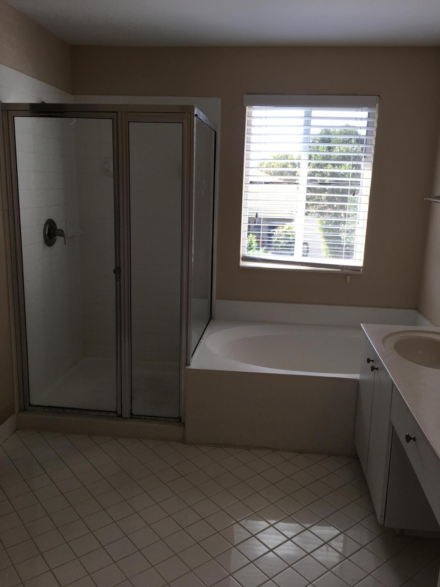 4383 Laurel Ridge Circle Weston, FL 33331 - Photo 24 of 36 a bathroom with a bathtub and a shower