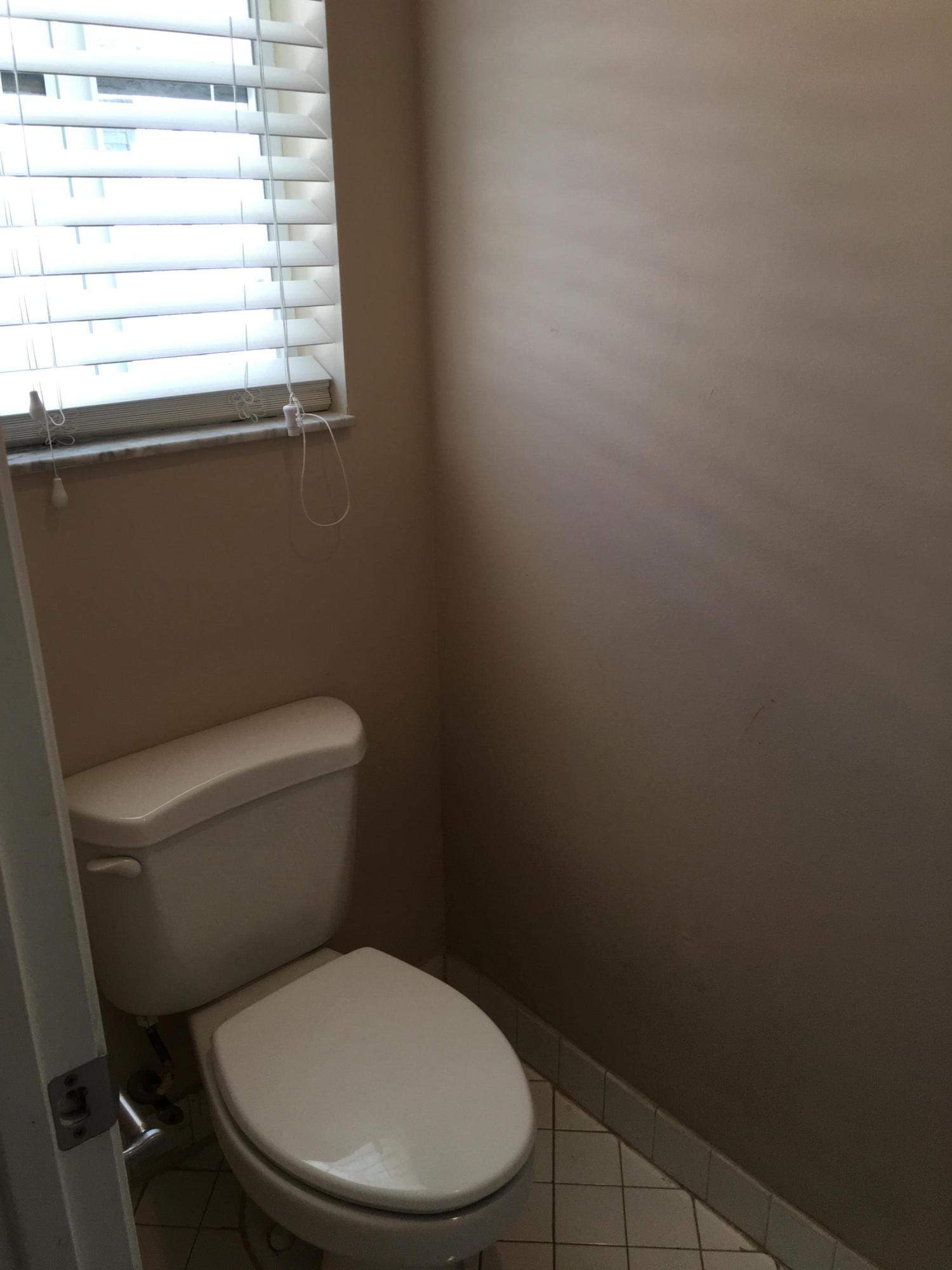 4383 Laurel Ridge Circle Weston, FL 33331 - Photo 25 of 36 a white toilet sitting in a bathroom next to a window