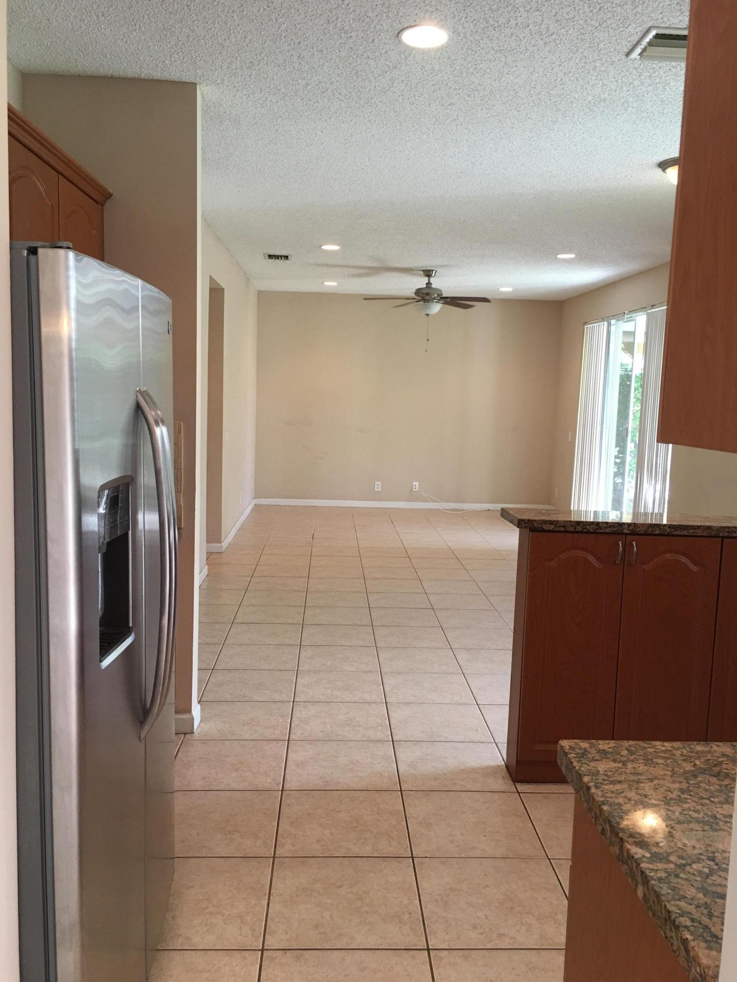 4383 Laurel Ridge Circle Weston, FL 33331 - Photo 7 of 36 a view of a refrigerator in kitchen and a living room
