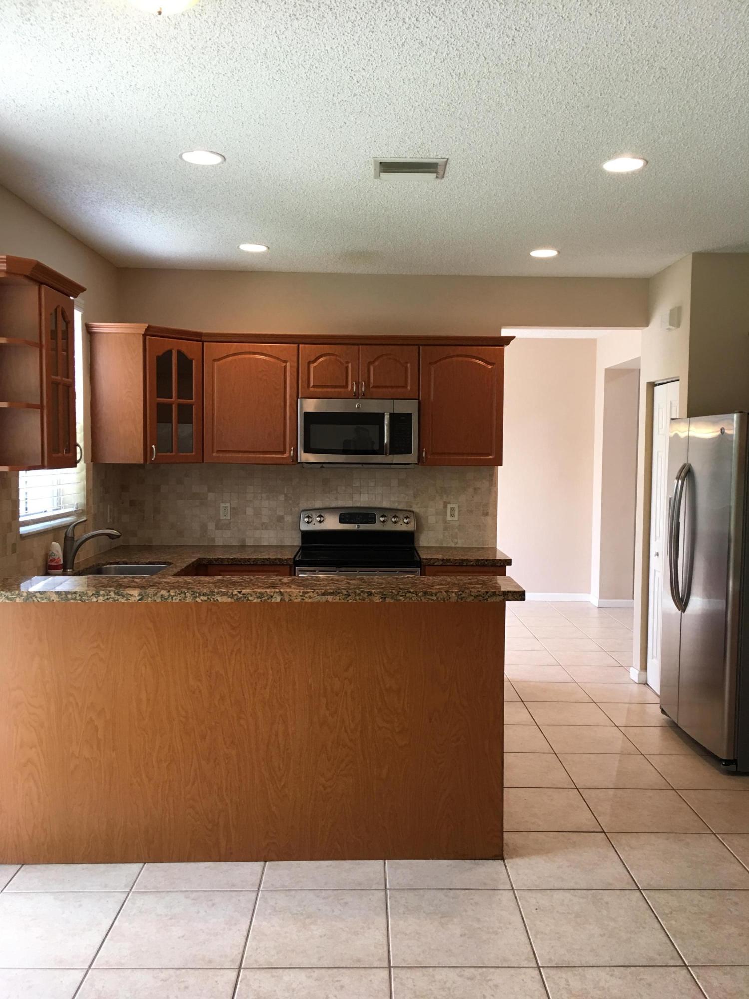 4383 Laurel Ridge Circle Weston, FL 33331 - Photo 8 of 36 a kitchen with stainless steel appliances granite countertop a refrigerator and a stove