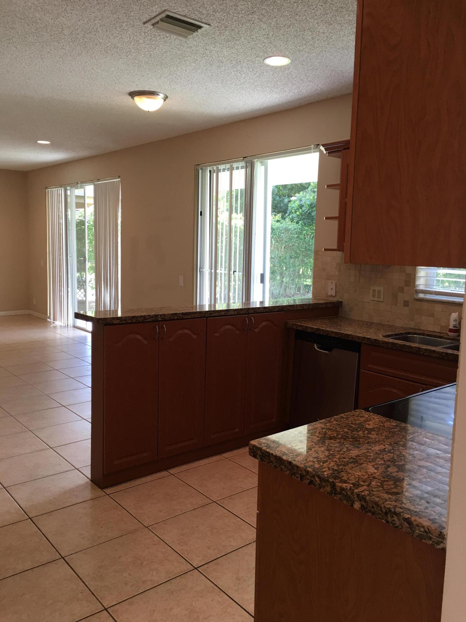 4383 Laurel Ridge Circle Weston, FL 33331 - Photo 10 of 36 a kitchen with a sink a counter top and a window
