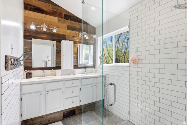 7935 Mustang Loop Road Park City, UT 84098 - Photo 44 of 60 Dual vanity with white cabinetry and integrated sinks, complemented by a reclaimed wood-paneled accent wall