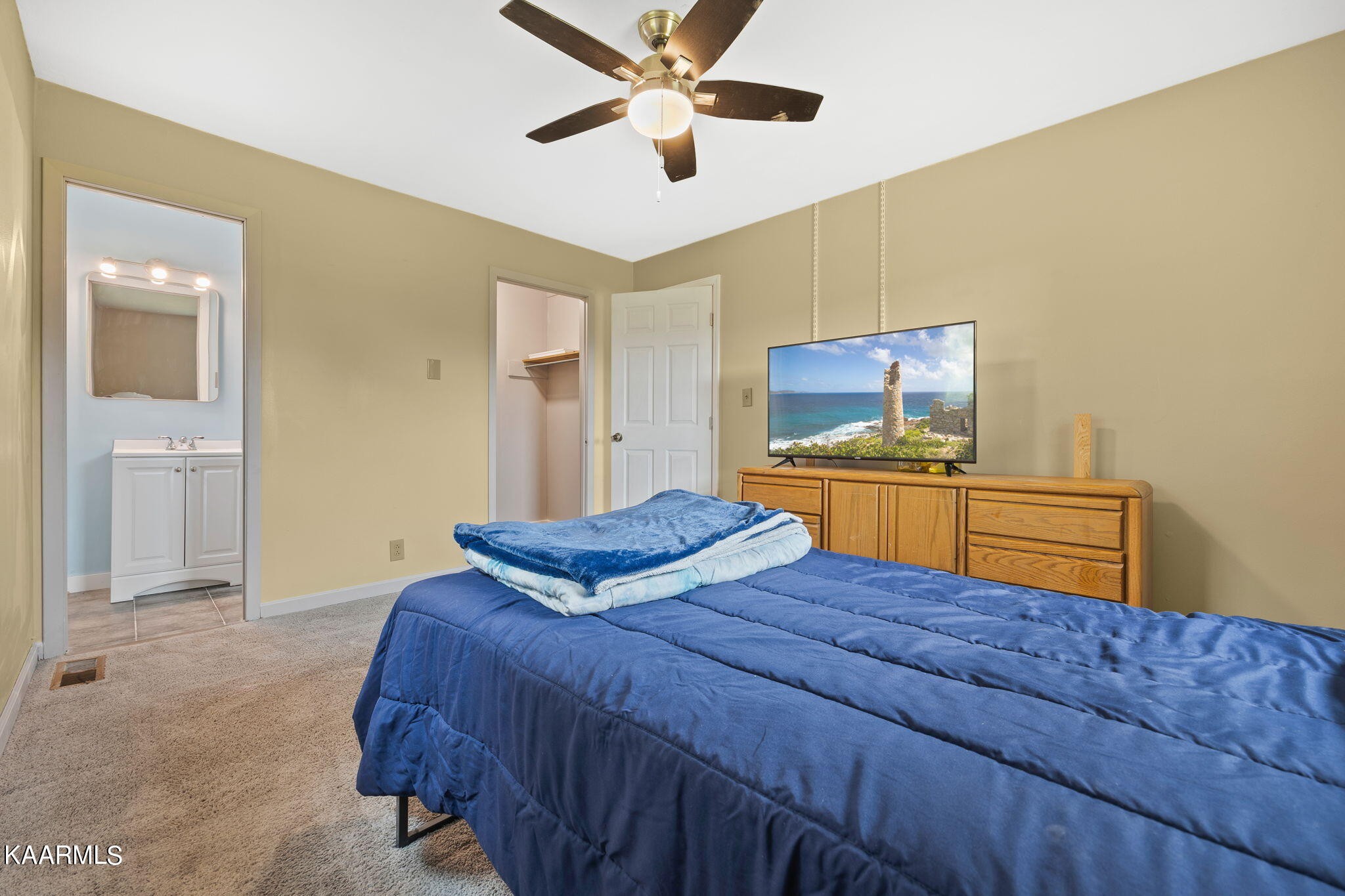 3325 Wade Road West, Unit W Loudon, TN 37774 - Photo 16 of 36 a bedroom with a bed and a chandelier