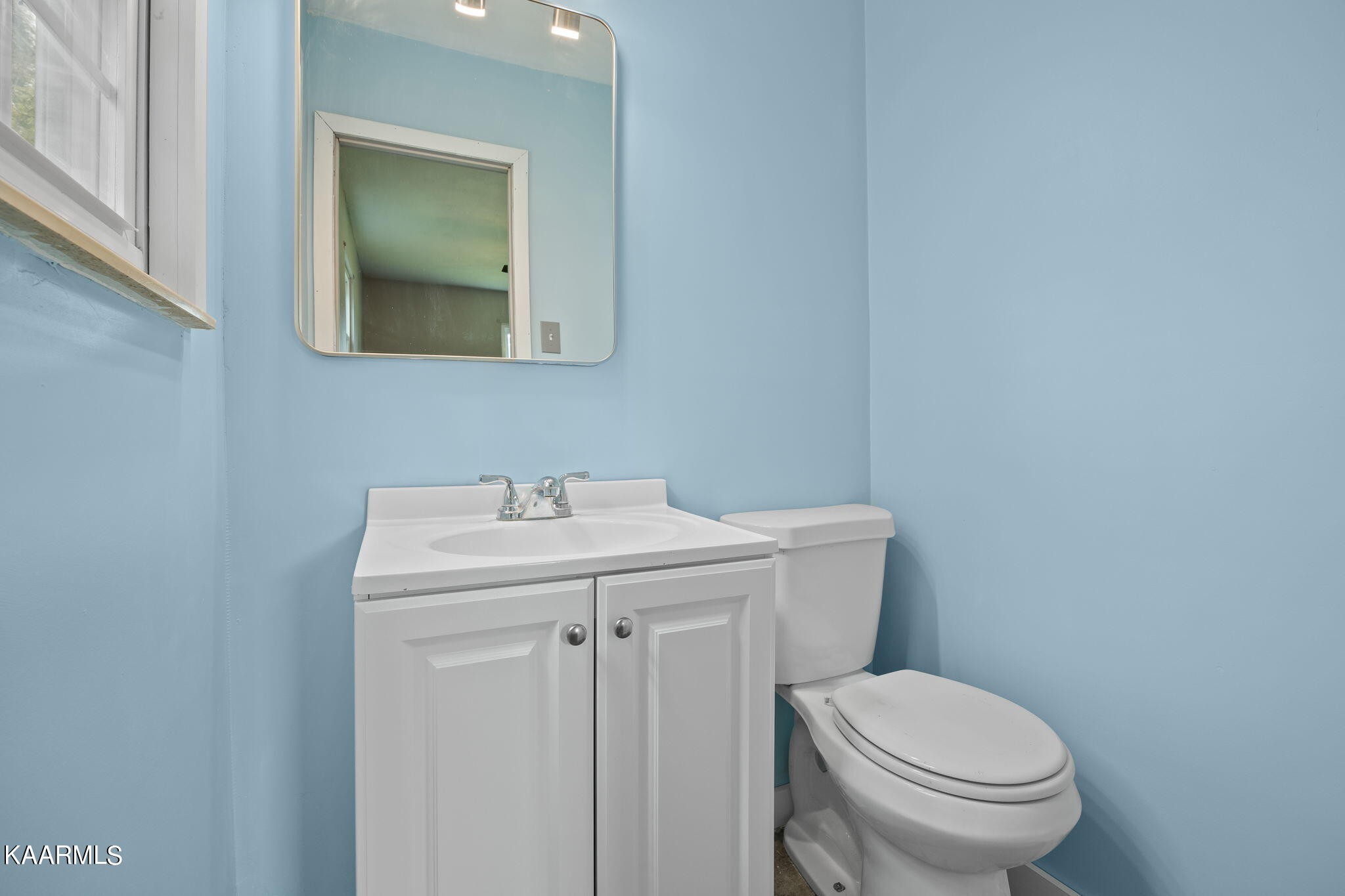 3325 Wade Road West, Unit W Loudon, TN 37774 - Photo 17 of 36 a bathroom with a sink a toilet and mirror