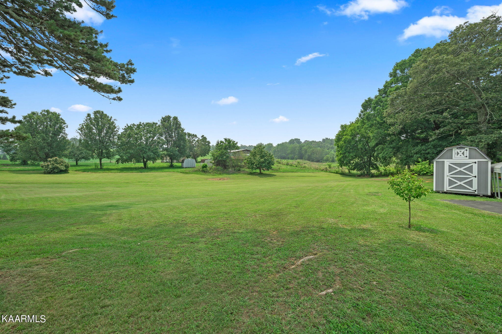 3325 Wade Road West, Unit W Loudon, TN 37774 - Photo 33 of 36 a backyard of a house with lots of green space and outdoor seating
