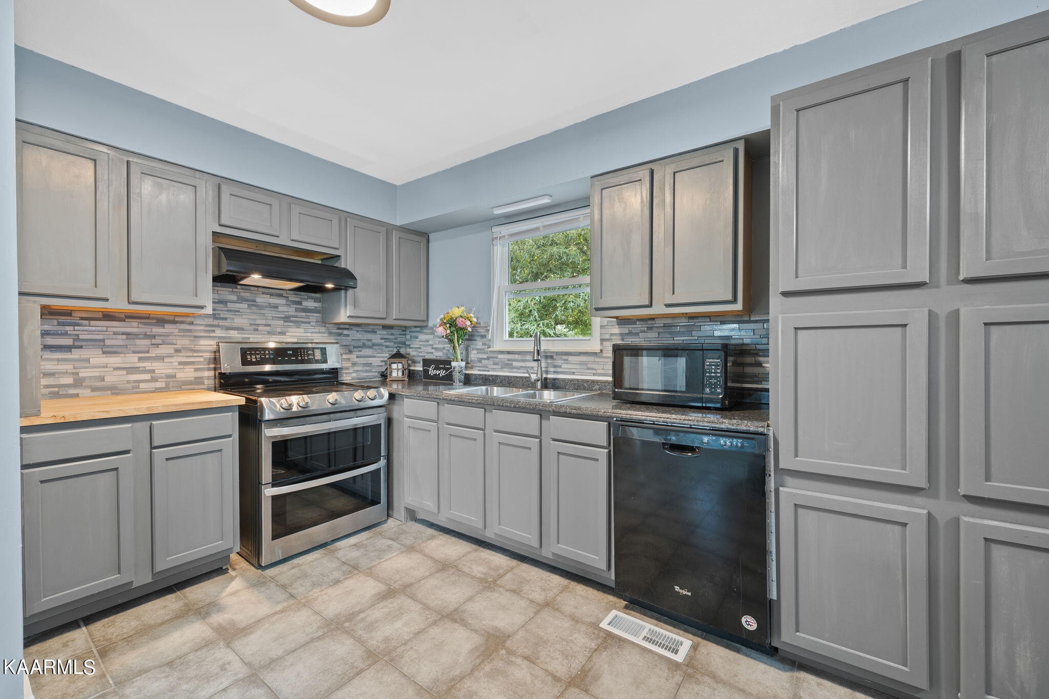 3325 Wade Road West, Unit W Loudon, TN 37774 - Photo 5 of 36 a kitchen with granite countertop a stove top oven sink and cabinets