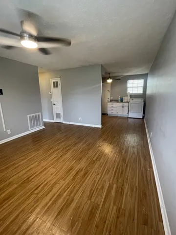 a view of a room with wooden floor
