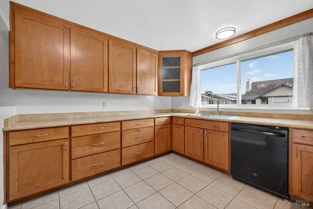 a kitchen with sink cabinets and window