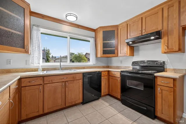 a kitchen with a sink stove and cabinets
