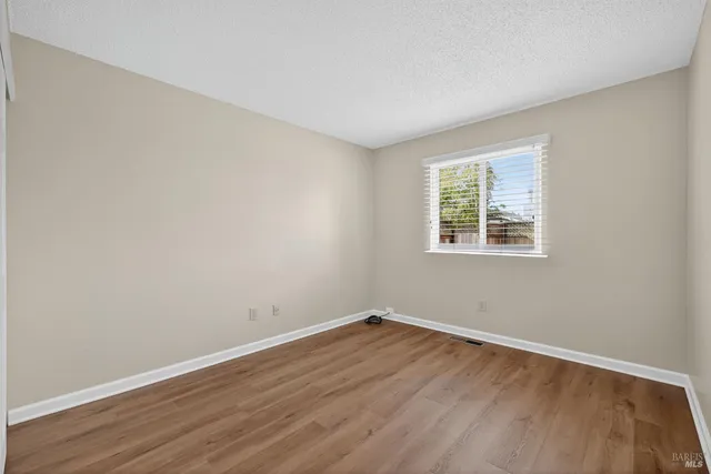 a view of a room with wooden floor and windows