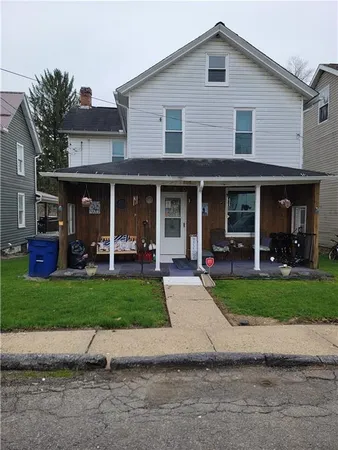 a front view of a house with a yard and porch