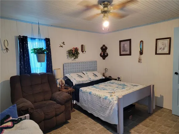a bedroom with a bed and a couch