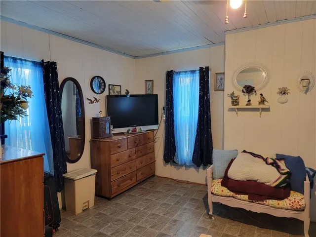 a room with furniture and flat screen tv
