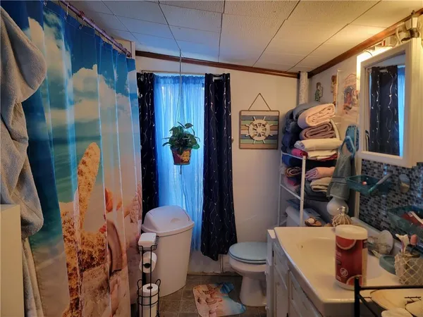 a bathroom with a toilet sink and mirror