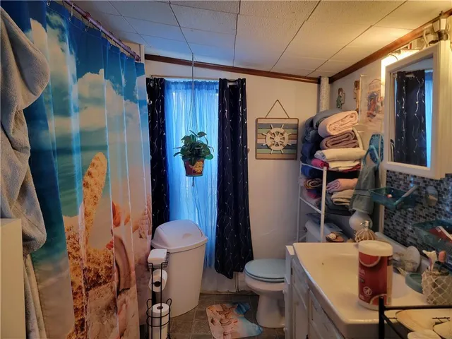 a bathroom with a toilet sink and mirror