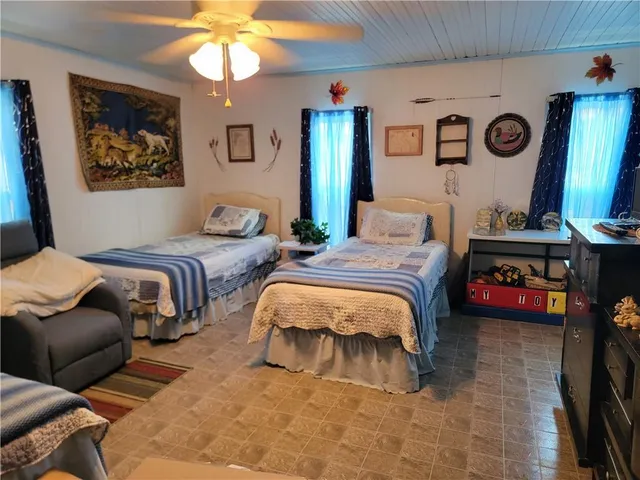 a bedroom with two beds and a chandelier