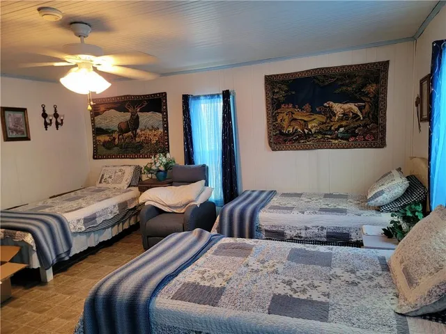 a bedroom with two beds and painting on the wall