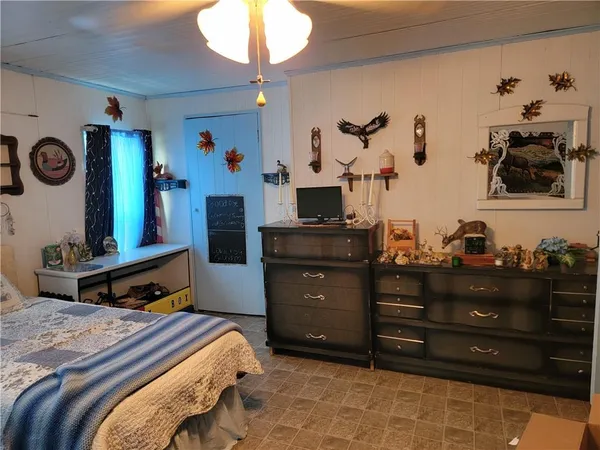 a bedroom with a bed and a dresser