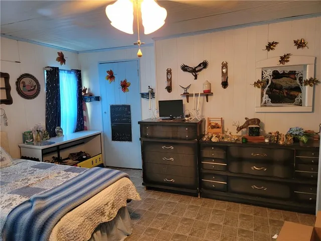 a bedroom with a bed and a dresser