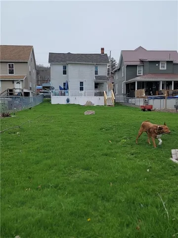 a view of a house with backyard porch and garden