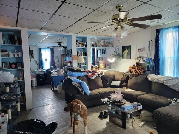a living room with furniture and a chandelier
