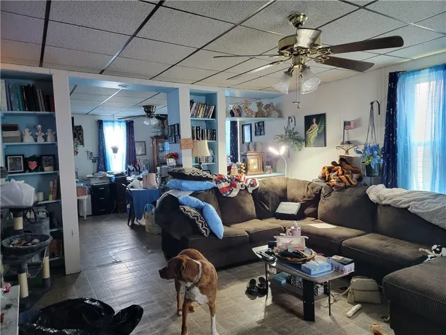 a living room with furniture and a chandelier