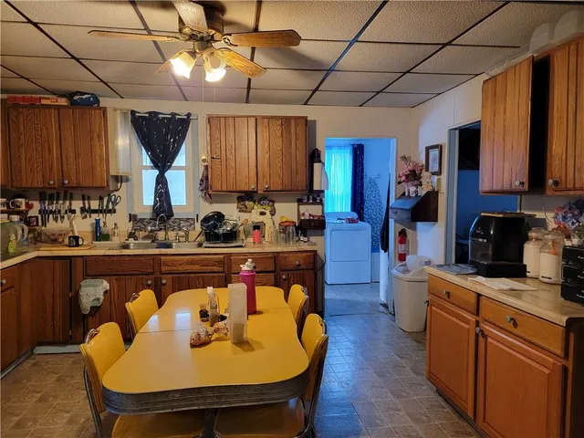 a kitchen with stainless steel appliances granite countertop a sink a stove and a refrigerator