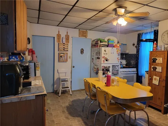 a view of a dining room with furniture and a chandelier
