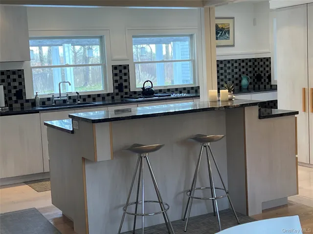 a kitchen with a sink and wooden cabinets