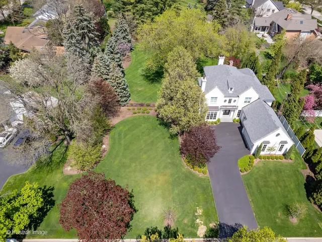 an aerial view of a house with a yard