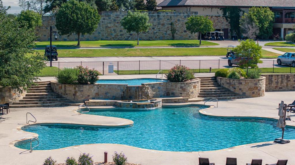 7308 Castle Royle Court Cleburne, TX 76033 - Photo 19 of 35 View of swimming pool with a patio area, an in ground hot tub, and pool water feature