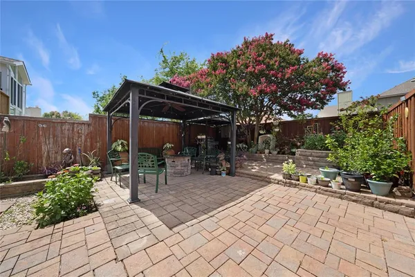 a patio with table and chairs