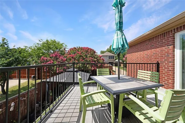 a view of a chairs and table in the backyard