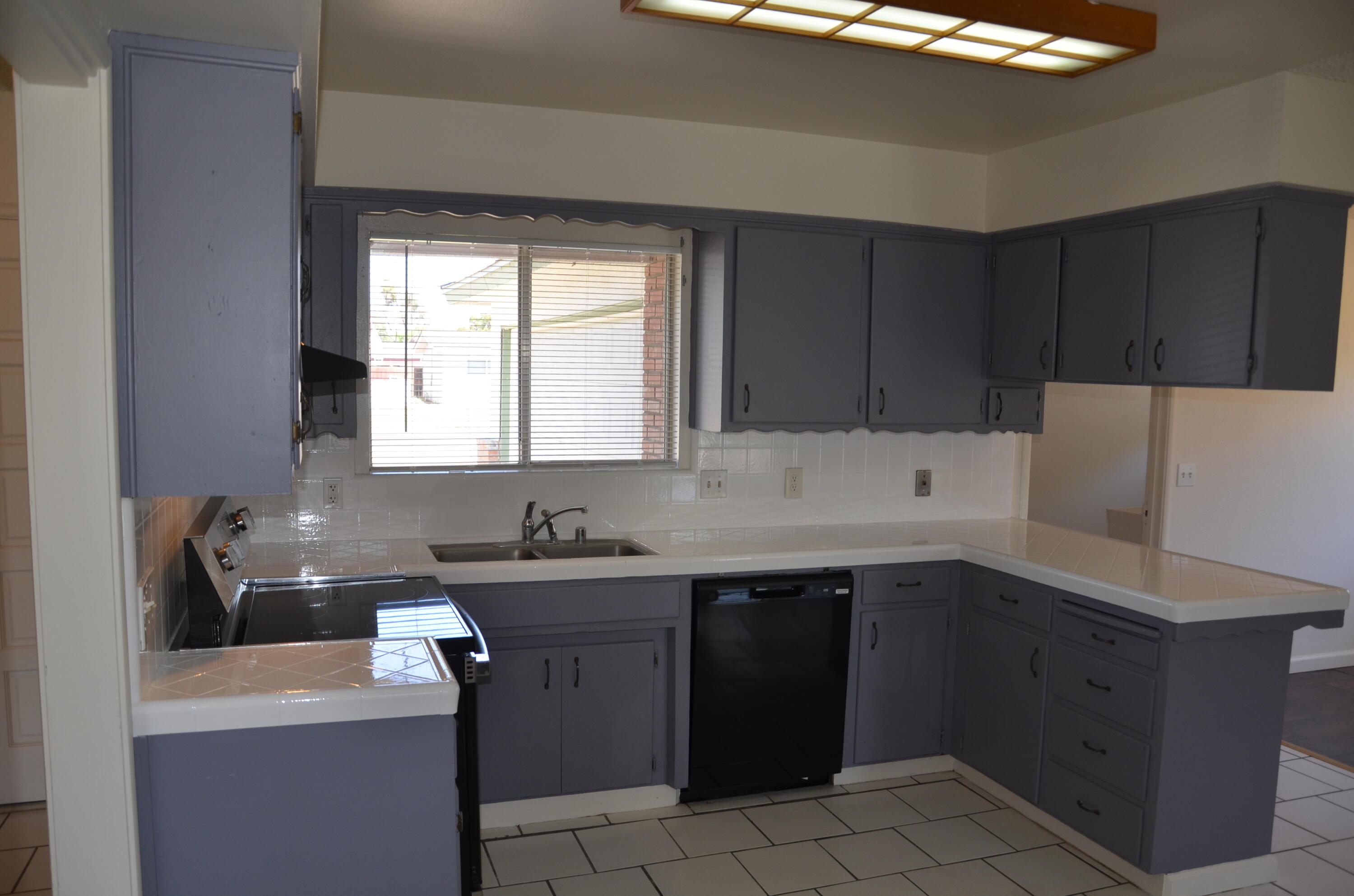 339 West Spring Lane Lemoore, CA 93245 - Photo 7 of 31 a kitchen with a sink dishwasher and cabinets