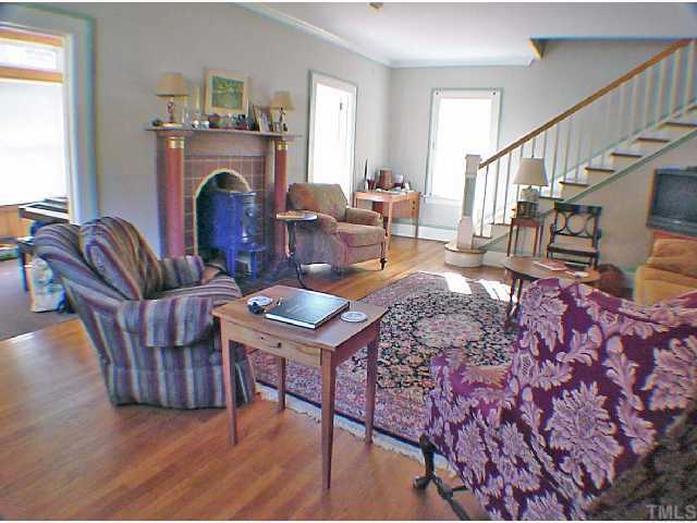 2605 Vanderbilt Avenue Raleigh, NC 27607 - Photo 2 of 10 Living room is spacious, light and bright, and features a fireplace with wood burning stove.