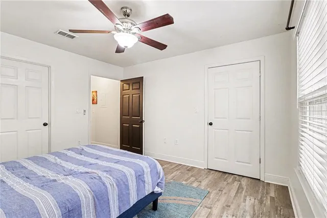a bedroom with a large bed and a chandelier