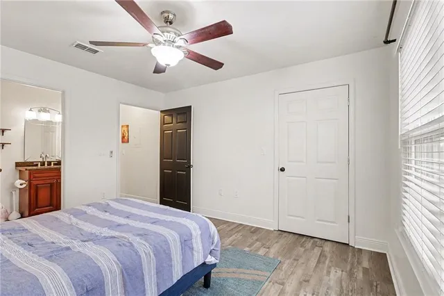 a bedroom with a bed wooden floor and window