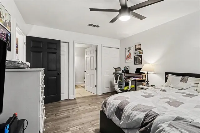a bathroom with a granite countertop sink a mirror and shower