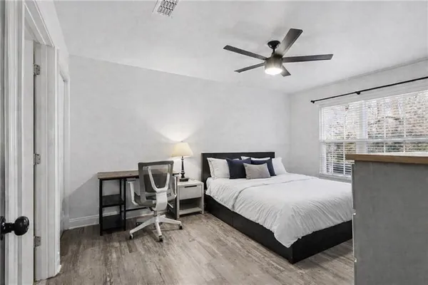 a bedroom with a bed a window and furniture