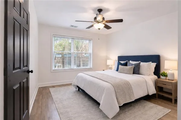 a bedroom with a large bed and a chandelier