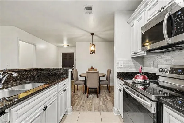 a kitchen with a stove and a sink
