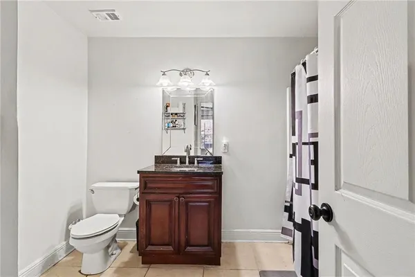 a bathroom with a toilet a sink and mirror